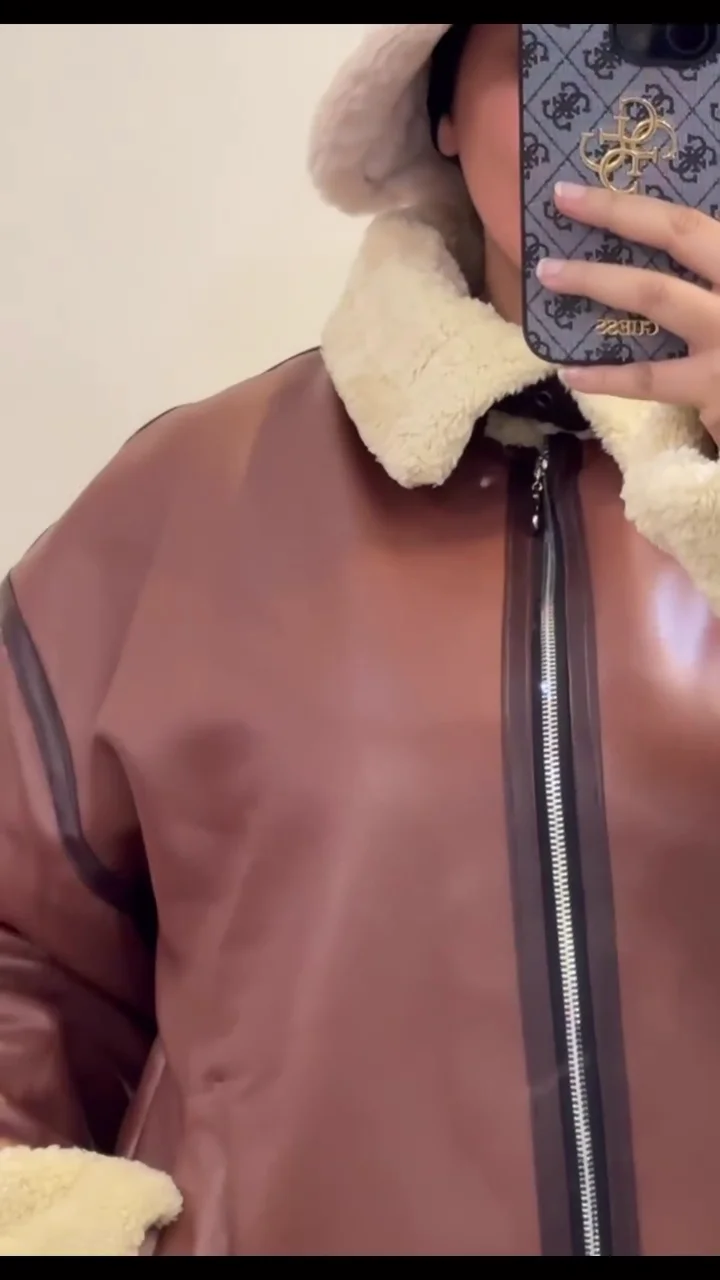 trendy oversized faux leather jacket with shearling lining and cuffs, warm fleece collar, paired with cozy beige knit sweater and soft plush bucket hat trendy oversized faux leather jacket with shearling lining and cuffs, warm fleece collar, paired with cozy beige knit sweater and soft plush bucket hat